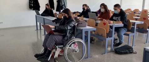 Una joven en silla de ruedas en un aula universitaria