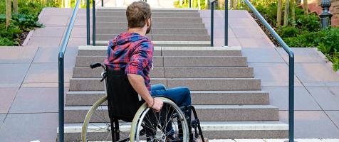 Imagen de un usuario de silla de ruedas ante unas escaleras