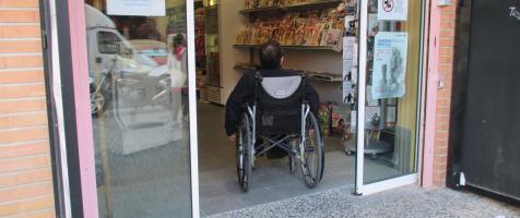 Una persona en silla de ruedas entra a un establecimiento